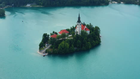 enchanting island with church at bled lake with calm blue water in bled, slovenia