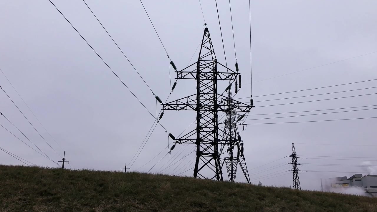 High Voltage Electricity Pylons Against a Cloudy Sky