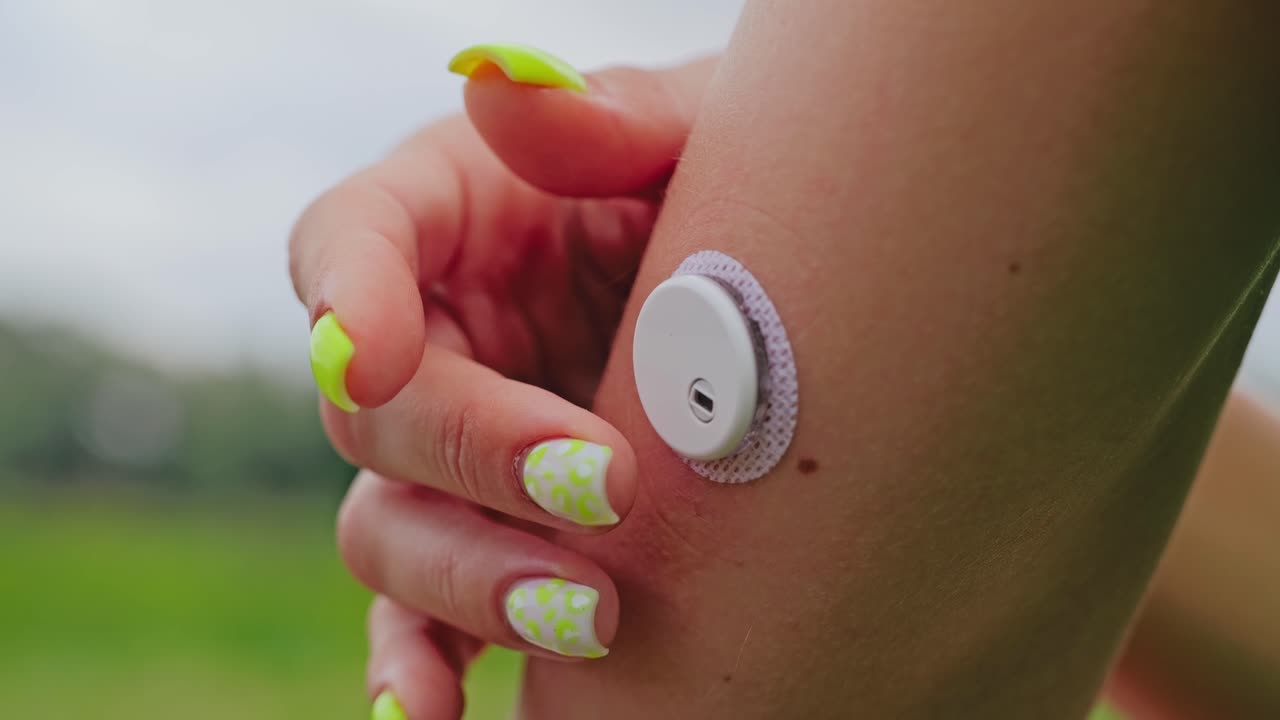 Emotional health concept showing female with glucose device feeling anxiety