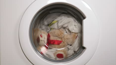 teddy bear washes in the washing machine.