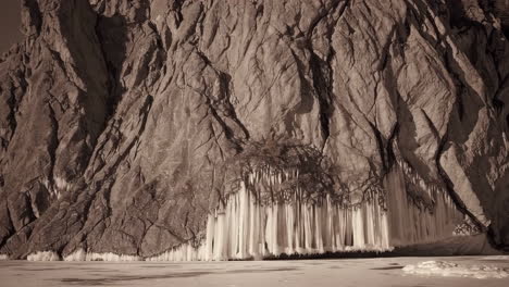 large icicle formations on a textured rock face