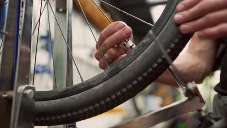 crop mechanic using wrench and adjusting bicycle wheel spokes