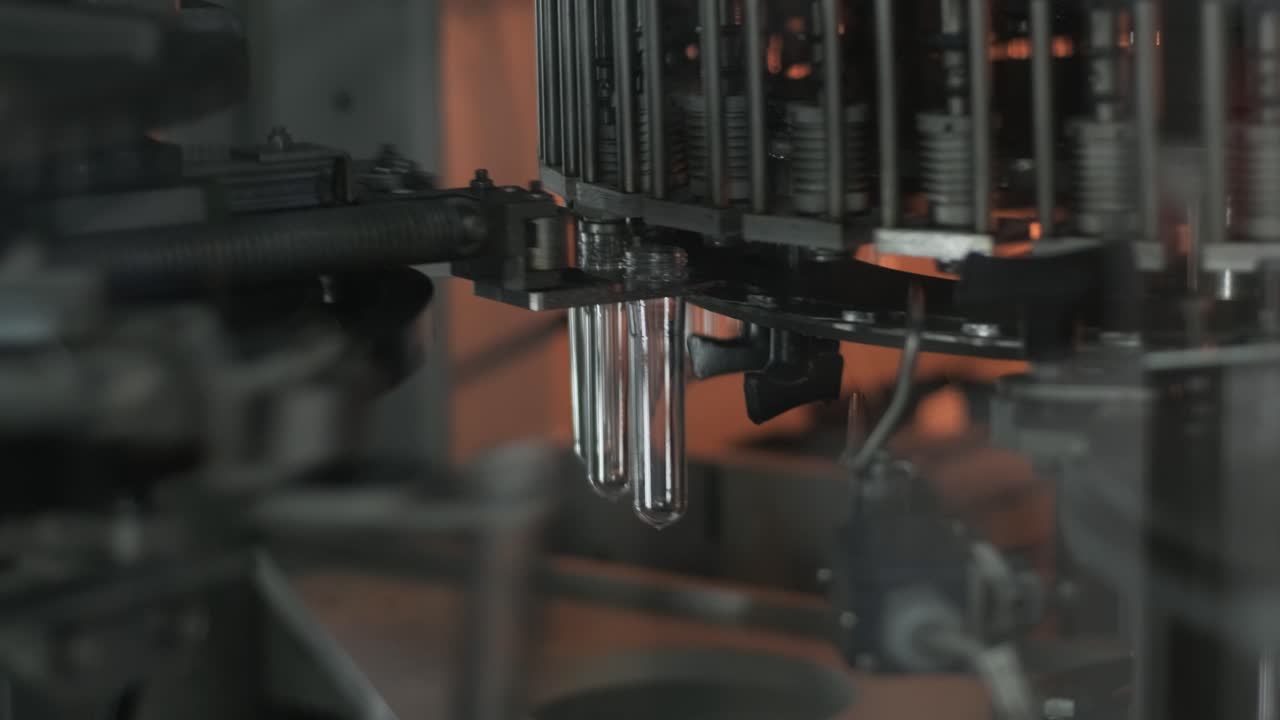 Automatic filling machine pours water into plastic PET bottles at modern beverage plant