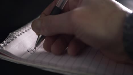 hand writing letter on paper notepad close up sho