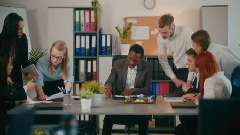 manager discussing with employees at workplace.