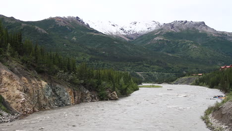 Fluss-Stürzt-Stromabwärts-Mit-Bergen-Und-Flößen-Im-Hintergrund-In-Alaska