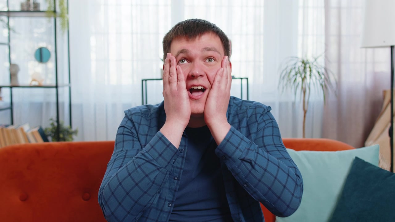 Excited shocked amazed young man surprised looking at camera with big eyes wow emotion good win news