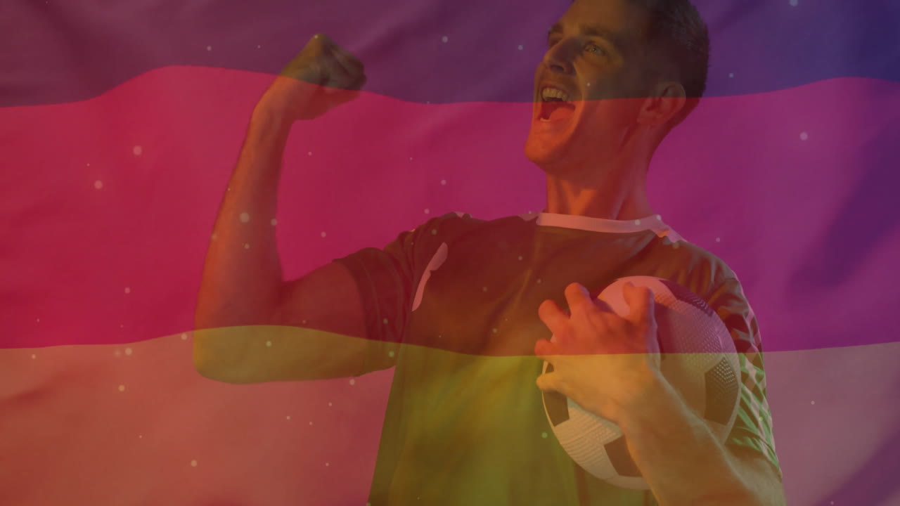animación de la bandera de alemania sobre un jugador de fútbol caucásico con una pelota