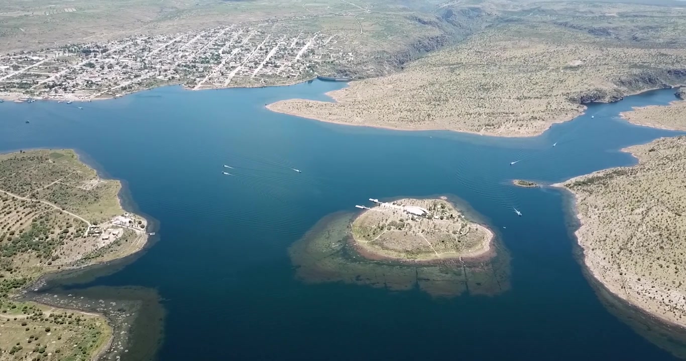 Panoramic shot of the new town of San José de Gracia, Aguascalientes, Mexico, flying over the Presidente Calles Dam, which is part of the "Pueblo Mágico" program