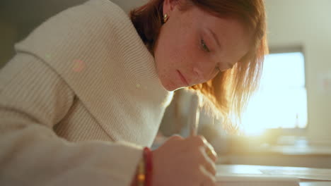 woman with red hair studying indoors