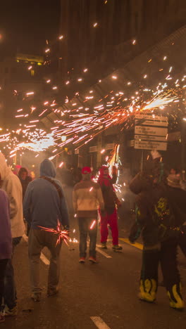 barcelona, spain - 22 september 2023 : crowds in the street for the fire run or correfoc, during la merce festival, barcelona spain in vertical