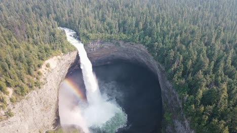 large and impressive helmcken fallsand a rainbow on the murtle river in british columbia, canada