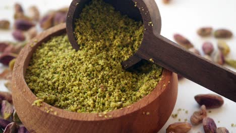 pistachio powder in a wooden bowl