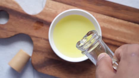 pouring oil into a bowl