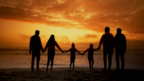 family at sunset on the beach