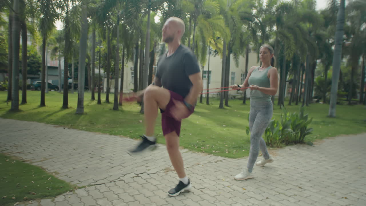 Man Having Outdoor Workout with Female Personal Trainer