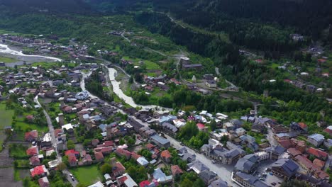 aerial shot of mestia township in caucasus mountains valley, georgia, 4k view