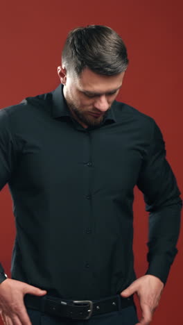 handsome brunette man. businessman with attractive appearance in black shirt on bright background. business concept. vertical video
