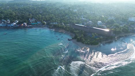 aerial drone landscape view of hotel resorts on turtle beach sandy ocean rocky reef bay coastline of hikkaduwa sri lanka asia travel tourism nature