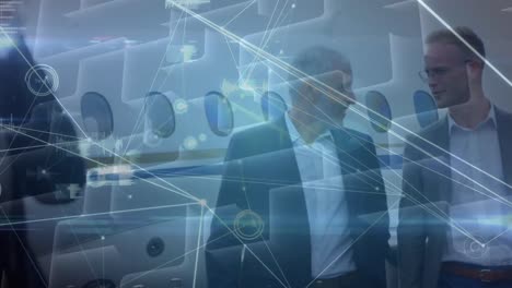 Animation-of-network-of-connections-over-caucasian-businessmen-on-airport