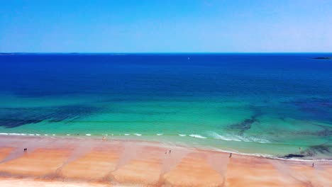 saco, maine peak-season drone shot: beaches alive with tourists and families. sand full of people, blue atlantic waves crash, vacation homes stand watch. a beautiful coastal view in new england