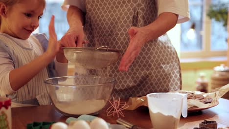 a little girl and her mother bake together