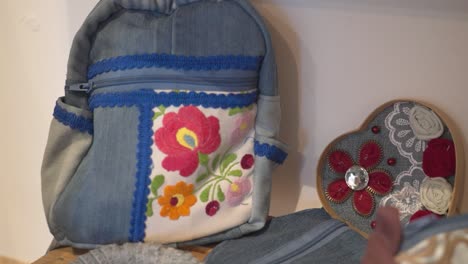 handmade denim backpack with colorful embroidery and decorative accents