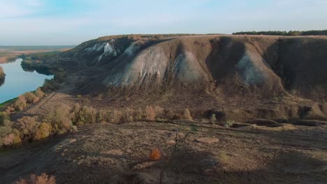 autumnal river valley with hills and cliffs