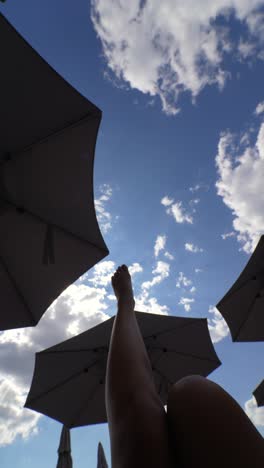 relaxing by the pool under umbrellas