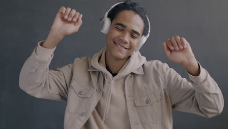 happy young man dancing while listening to music