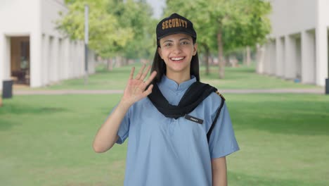 happy indian female security guard waving hello