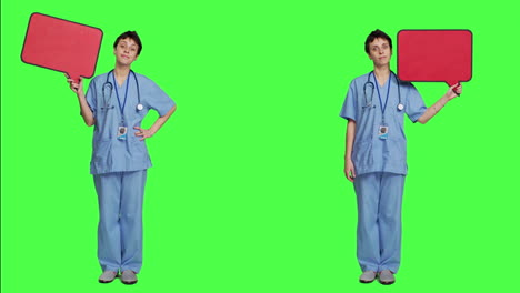 Medical-assistant-holding-a-red-speech-bubble-icon-against-greenscreen