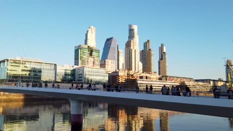 puerto madero, buenos aires city in woman’s bridge touristic landmark, sunset skyline over skyscrapers