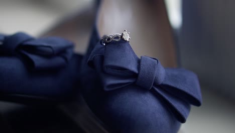 bride's wedding ring sits on top of her shoes in a large window sill