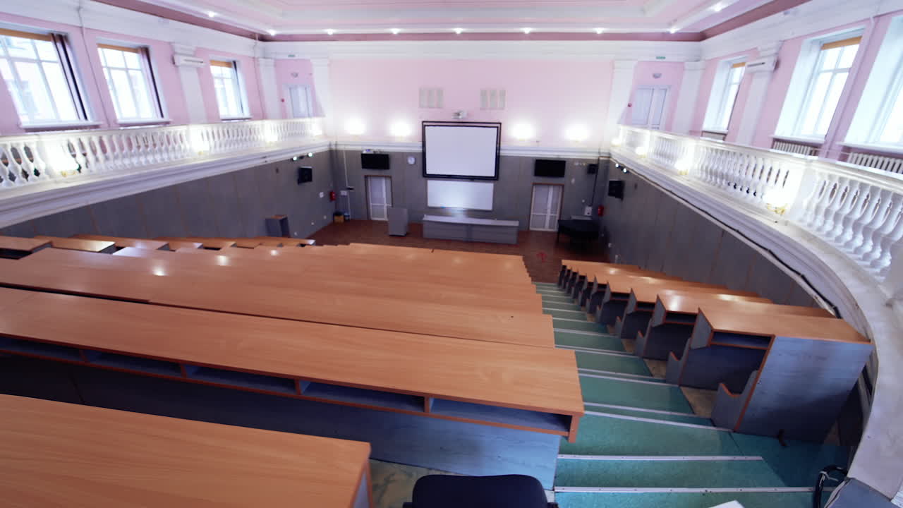 Tables and chairs in classroom. Modern wooden lesson in conference room