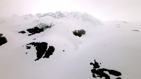 Aerial-take-from-a-mountain-in-the-swiss-Alps,-nearby-the-Diablerets-region