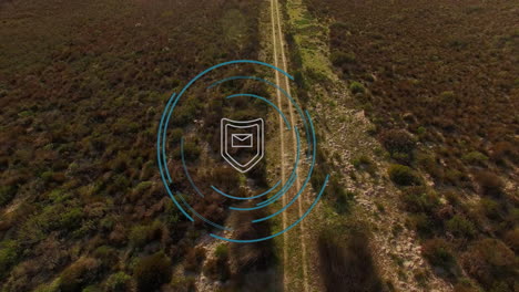 email security icon animation over aerial view of rural landscape