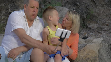 grandparents and grandchild making funny mobile selfie