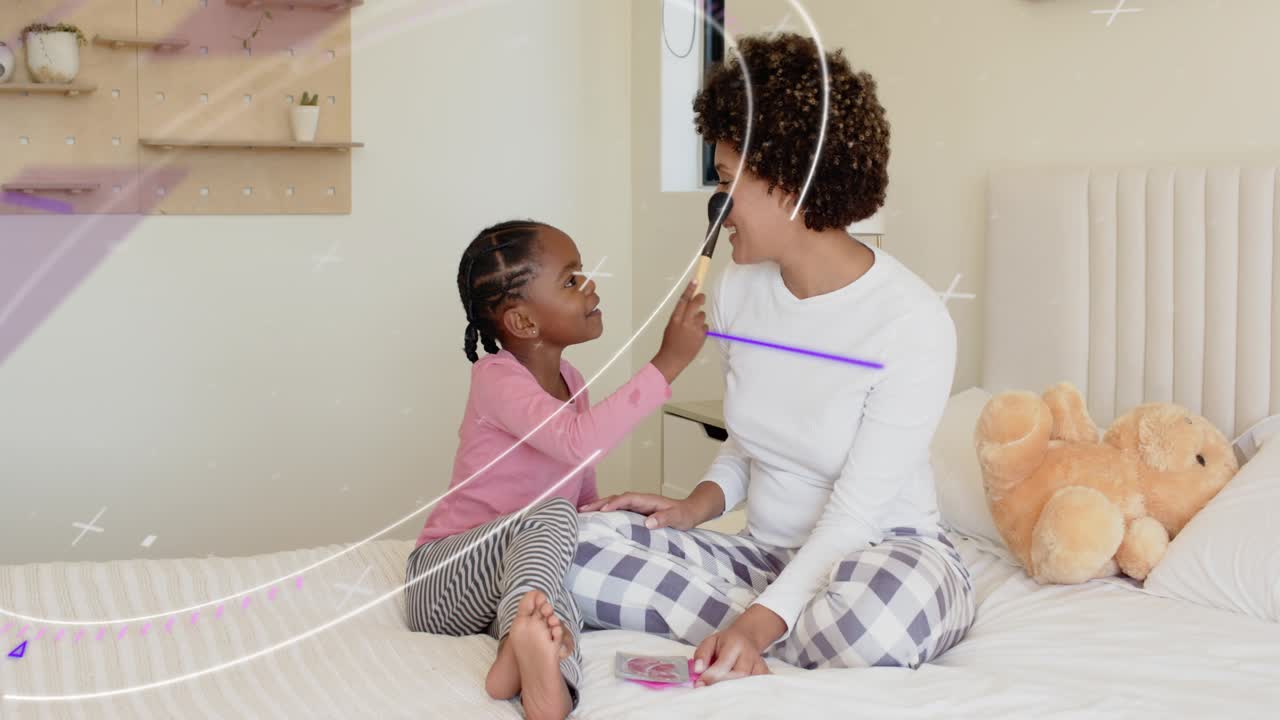 Child picking up brush, applying blush to woman on bed, purple overlays showing beauty bonding