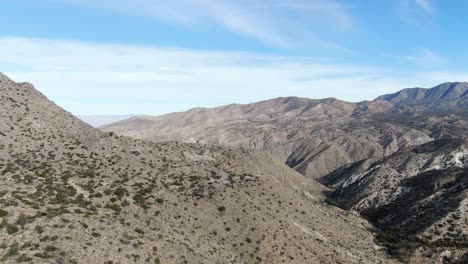 car driving on scenic winding road surrounded by cahuilla mountains, scenic curve road through vast desert landscape, california, usa