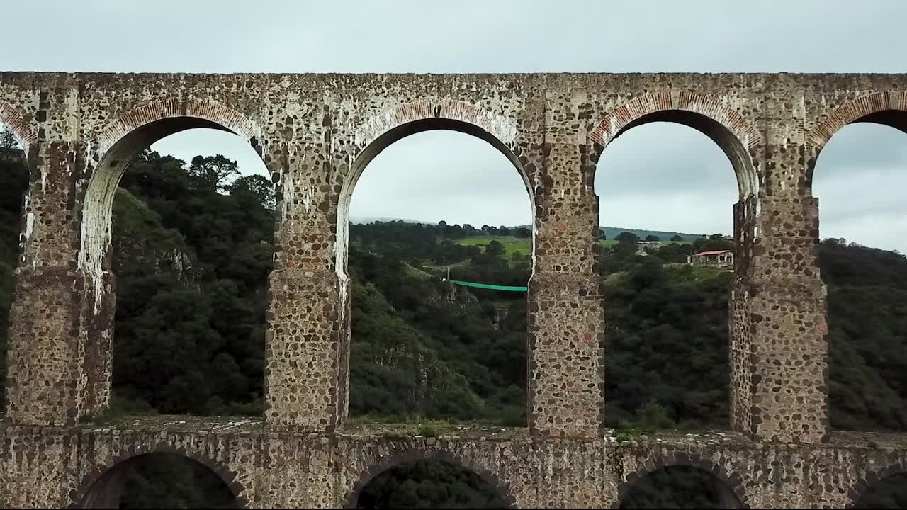 Drone flight shot crossing one of the arches of the historic site "Arcos del Sitio" in Tepotzotl&aacute;n, State of Mexico, Mexico