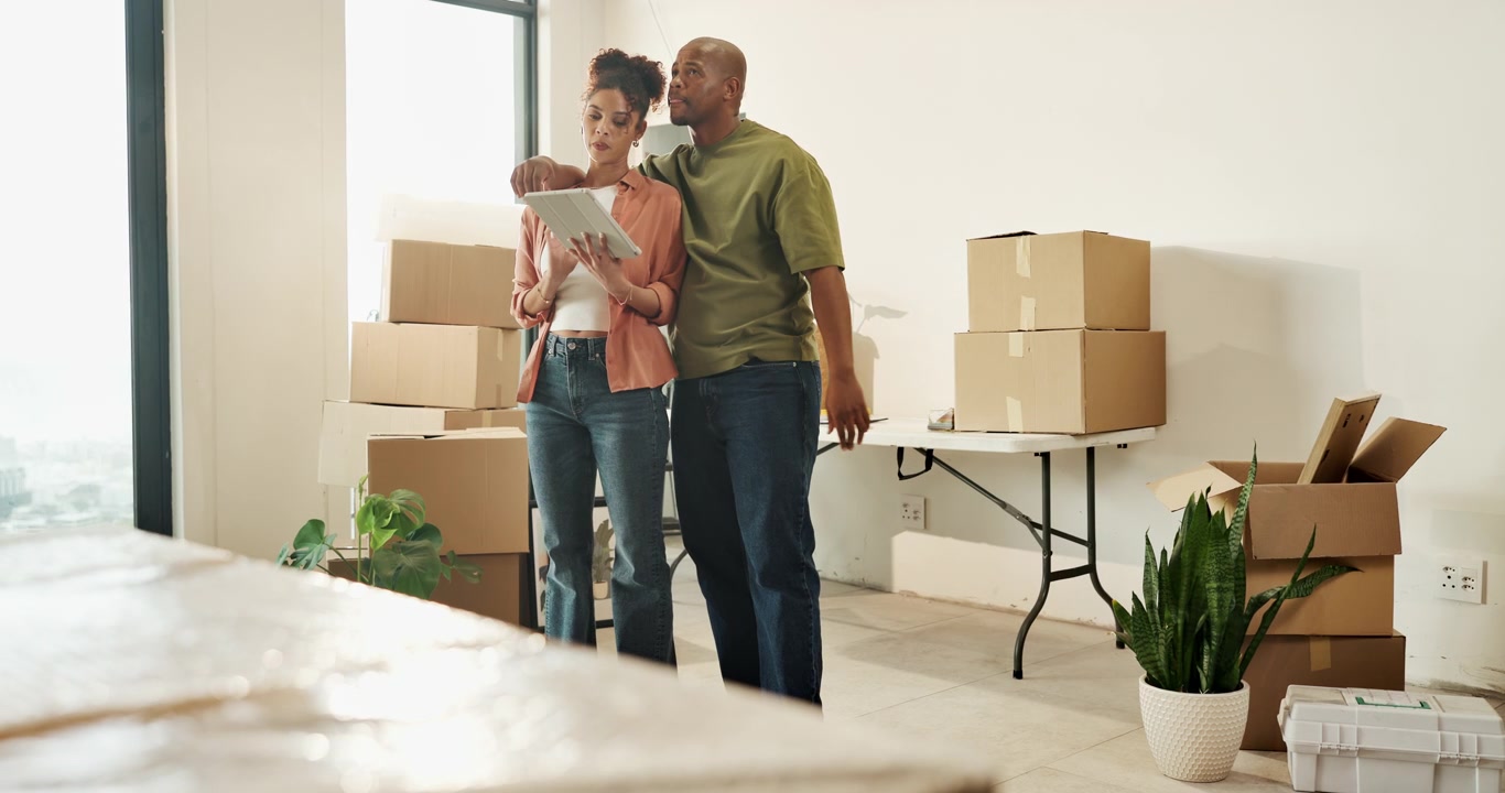 Couple Planning Interior Design in New Home with Moving Boxes