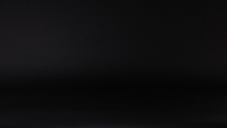 Tennis ball bouncing against a dark background