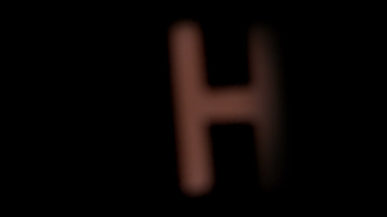 The letter h rising on black background