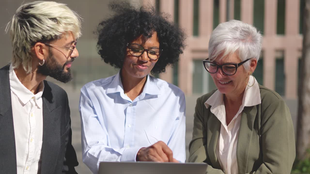 Diverse Team Collaborating on a Laptop