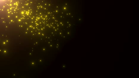 pequeñas partículas amarillas y estrellas en fondo oscuro