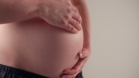 close up of the stomach of a woman in advanced pregnancy