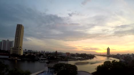 sunset over the chao phraya river in bangkok, thailand