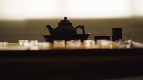 chinese tea set and glass chinese chess on the golden chess board