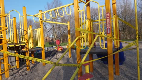 caution tape on empty swing set playground - coronavirus covid-19 quarantine lock down